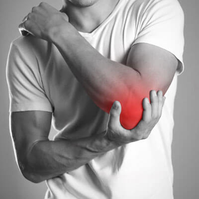 man holding elbow in pain